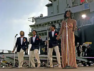 Gladys Knight & the Pips perform aboard the aircraft carrier USS&nbsp;Ranger on November 1, 1981. Left to right: William Guest, Edward Patten, Merald "Bubba" Knight, and Gladys Knight.