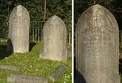 Two granite headstones in a grassy cemetery