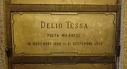 A marble gravestone on the wall of a crypt