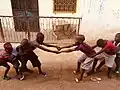 Children engaging in traditional Tug of War game