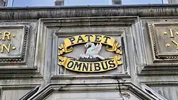 Crest with motto "Patet Omnibus" ("Open to All")