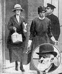 Swan being escorted from court, overseen by a police officer