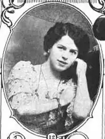 Young white woman's face and arms in oval frame.