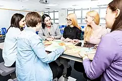 Group of students in conversation with a lecturer