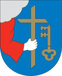 Hand holding Christian cross in the coat of arms of Pärnu