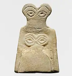 Eye idol; 3700–3500 BC; gypsum alabaster; 6.5 × 4.2 × 0.6&nbsp;cm; Metropolitan Museum of Art