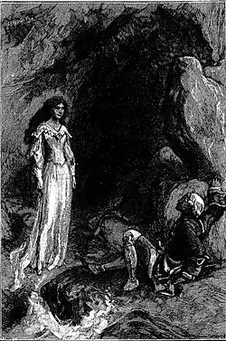 A lady standing at the entrance to a cave and a fallen man facing her.