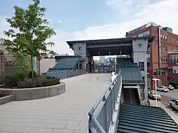 An elevated deck leading to a footbridge at a railway station