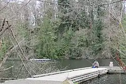 An angler sitting on a dock