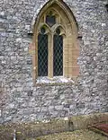A flint church – the Parish Church of Saint Thomas, in Cricket Saint Thomas, Somerset, England. The height of the very neatly knapped flints varies between 3 and 5 inches (7.6 and 12.7&nbsp;cm).