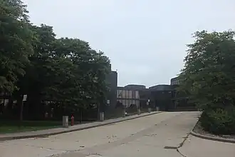 driveway leading from the street to the entrance of a modern three-story office building