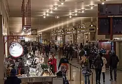 A long hallway with track entrances and food vendors