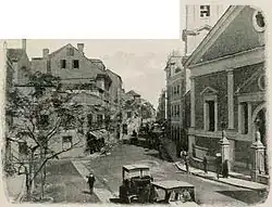 Old photograph of Main Street showing part of the cathedral's façade to the left. Picture from the book Gibraltar - John L. Stoddard's Lectures (1912), by John L. Stoddard. It shows the old façade built in 1810.