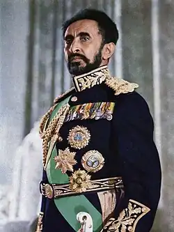 Selassie, in his seventies, with a full beard, wearing formal military dress uniform.