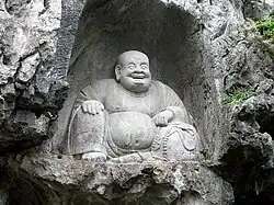 Sculpture of Budai at the Feilai Feng grottoes in Zhejiang, China. Northern Song dynasty, 11th century.