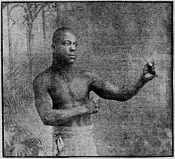 Image of shirtless Harris Martin with his bare fists raised.