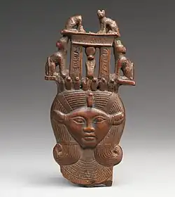 Head of Hathor from a clapper; 1295–664&nbsp;BC; possibly boxwood; 12 × 6.2&nbsp;cm; Metropolitan Museum of Art