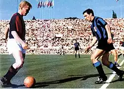 One player has the ball, and another is preparing to tackle