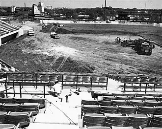 A black and white photograph showing a baseball field being built
