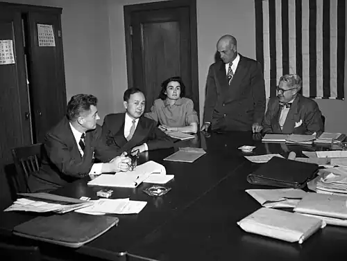 Qian at his deportation hearing, 1950. Others, from left, are Grant B. Cooper, Xuesen's attorney; a hearing reporter, Albert Del Guercio, examining officer, and Ray Waddell, hearing officer.