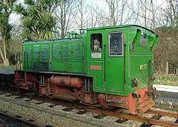 Four-wheel diesel engine with light green body and a faded red chassis