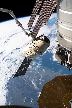 Dragon grappled by the ISS