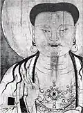 Details of the main image: the jewel ring worn on the chest, the black square pattern on the white robe
