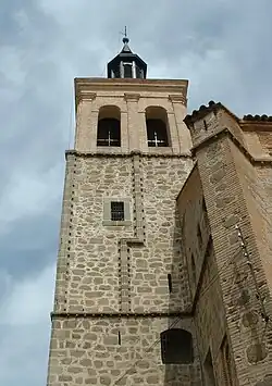 A stone tower. Crosses can be seen in the windows.