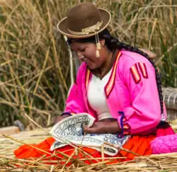 A Uro woman knitting.