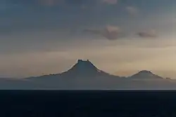 Isanotski (8,104 ft; 2,470 m) and Roundtop (6,128 ft; 1,868 m) volcanoes as seen from the Unimak Pass in the morning light.