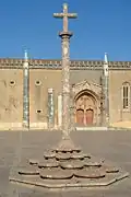 Cruzeiro (a Stone cross) and façade of the Monastery of Jesus of Setúbal.
