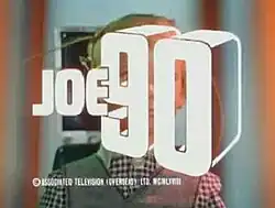 Bold white lettering forming the words "Joe 90" is superimposed over the face of a young, blond-haired boy who has sets of wires connected to his head.