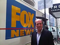 Peyronnin standing next to the first satellite truck owned by FOX News in 1995