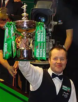 John Higgins holding a trophy