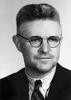 Black and white photograph of a middle-aged man wearing a business suit