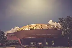 The Golden Rondelle Theater, a round structure with a golden roof. The theater was built for the 1964 New York World's Fair and then relocated to the Johnson Wax Headquarters.
