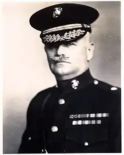 an image of a white male in his military uniform with a hat on and a mustache. Military style ribbons are clearly visible.