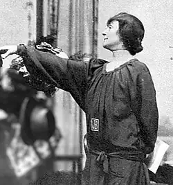 elegant middle-aged woman, extending a gracious hand