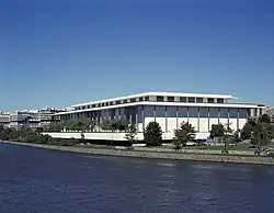 A photograph of the John F. Kennedy Center for the Performing Arts as seen over the water