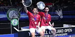 Kevin Sanjaya Sukamuljo and Marcus Fernaldi Gideon pose at the 2017 All England Open podium