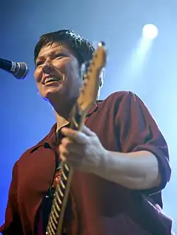 Kim Deal playing guitar and singing on stage at All Tomorrow's Parties festival, 2009