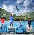 A kiteboarder soars over cheering fans at Saba Rock Resort, British Virgin Islands