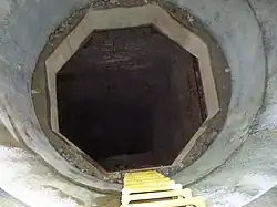 Kites Shaft (disused), a typical old Cornish mine shaft; it has been boxed and had new fittings round the top for public safety