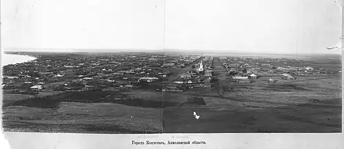 A 19th-century panorama view looking into the city of Kokshetau before rebuilding as seen from the Bukpa Hill Lookout. The Lake Kopa is visible to the left, and the St George's Church to the right.