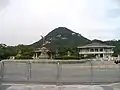 Monument on the road in front of the Cheong Wa Dae, administrative building in the background