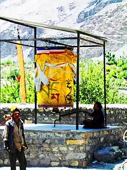 Large prayer wheel being turned. Spiti