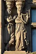 Left pair of caryatids, one, with harp, representing Ireland; first floor, bay five, Princes Street façade
