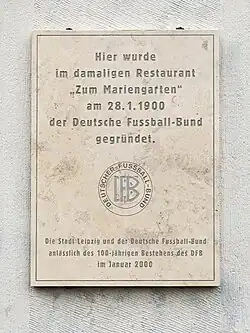 German plaque outside Zum Marriengarten, which translates into English as "Here, in the former 'Zum Marriengarten' restaurant, the German Football Association was founded on 28 January 1900." Underneath this text is an inscription noting that the German Football Association and city of Leipzig put up this plaque on the 100th anniversary in the year 2000.
