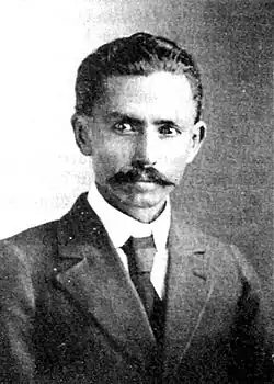 Portrait photograph of Rivera, wearing a suit and a moustache with slicked back hair