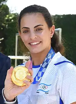 Ashram showing her Olympic gold medal